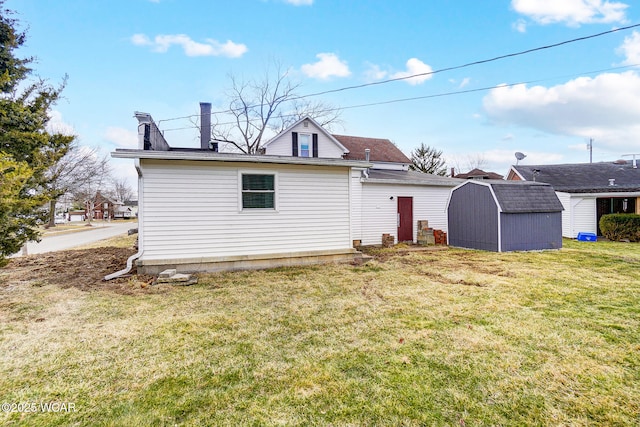 rear view of house with a storage shed, an outdoor structure, and a lawn