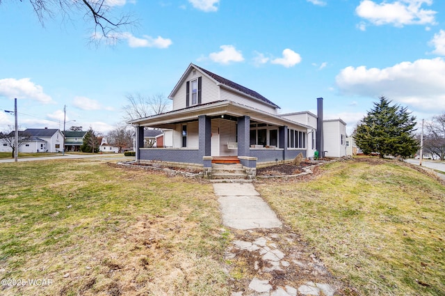 view of front of house with covered porch and a front yard