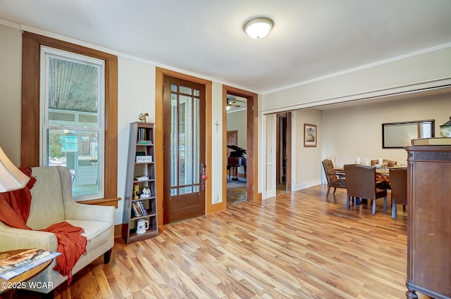 office area with light wood-style flooring, french doors, baseboards, and ornamental molding