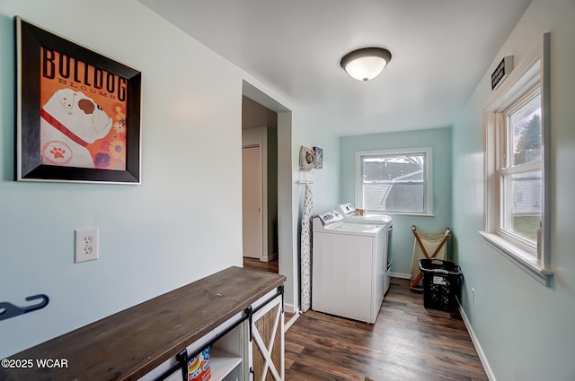 washroom with washer and dryer, laundry area, dark wood finished floors, and baseboards