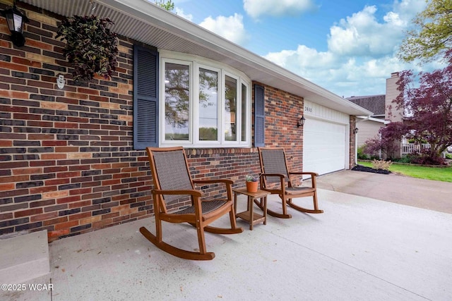 2440 E Bluelick Rd, Lima, OH 45801 - view of patio / terrace featuring an attached garage and concrete driveway