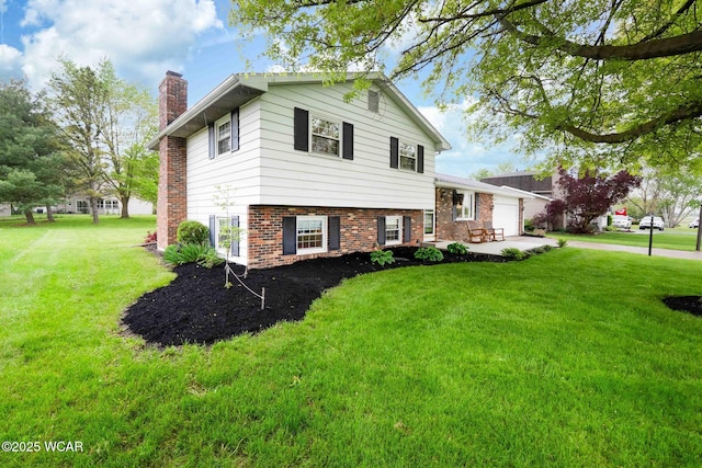 2440 E Bluelick Rd, Lima, OH 45801 - split level home with a chimney, brick siding, a front lawn, and a garage