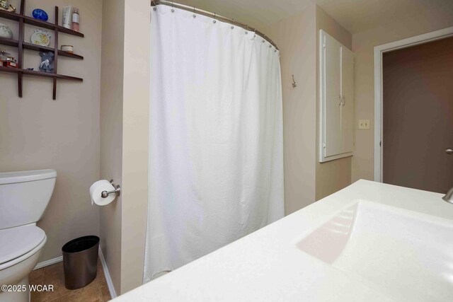 2440 E Bluelick Rd, Lima, OH 45801 - bathroom featuring a sink, toilet, tile patterned floors, and a shower with curtain