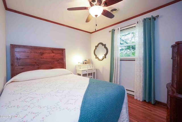 2440 E Bluelick Rd, Lima, OH 45801 - bedroom with wood finished floors, baseboard heating, ornamental molding, baseboards, and ceiling fan
