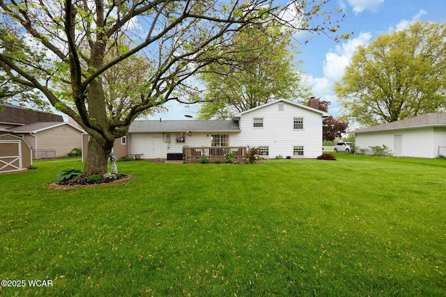 2440 E Bluelick Rd, Lima, OH 45801 - rear view of property with a yard, a deck, a chimney, an outdoor structure, and a storage unit