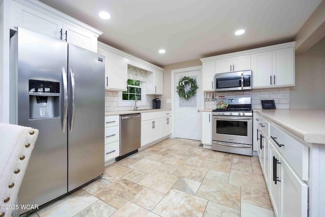 2440 E Bluelick Rd, Lima, OH 45801 - kitchen featuring stainless steel appliances, tasteful backsplash, white cabinets, and recessed lighting