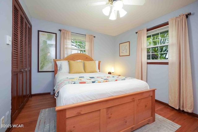 2440 E Bluelick Rd, Lima, OH 45801 - bedroom featuring light wood-style flooring, multiple windows, and baseboards