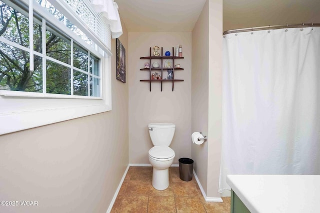 2440 E Bluelick Rd, Lima, OH 45801 - full bath with baseboards, toilet, and tile patterned flooring
