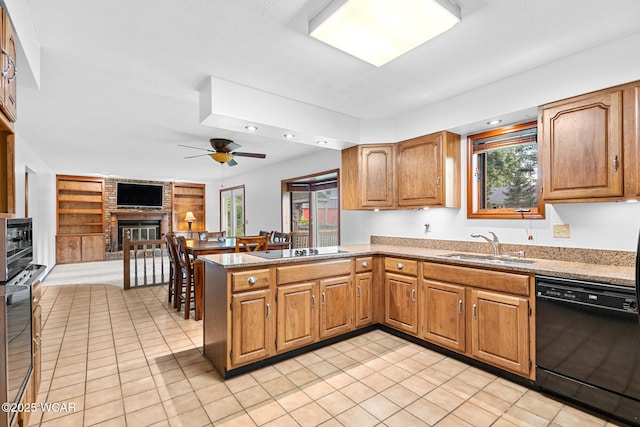 800 Heritage Dr, Lima, OH 45804 - kitchen with black appliances, light tile patterned floors, a brick fireplace, ceiling fan, and recessed lighting
