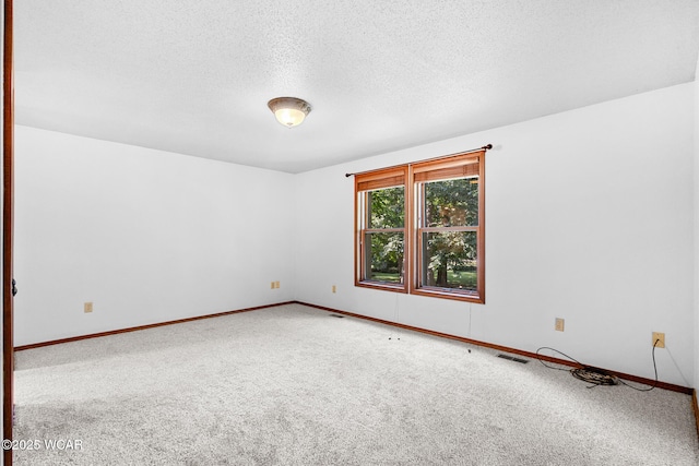 800 Heritage Dr, Lima, OH 45804 - spare room featuring carpet and a textured ceiling