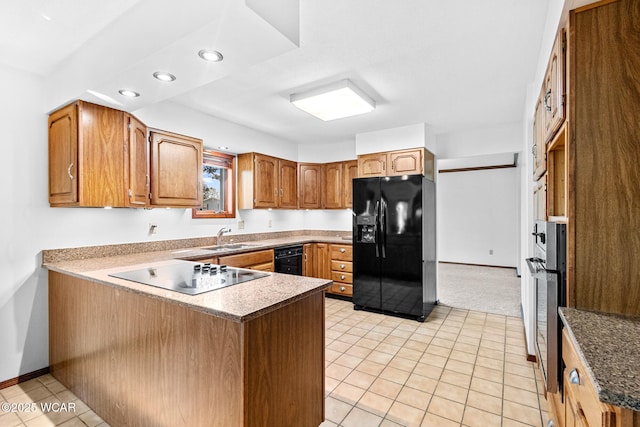 800 Heritage Dr, Lima, OH 45804 - kitchen with black appliances, a peninsula, recessed lighting, brown cabinetry, and light tile patterned flooring
