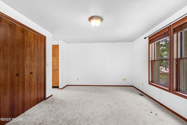 800 Heritage Dr, Lima, OH 45804 - unfurnished bedroom with carpet floors, a closet, and a textured ceiling