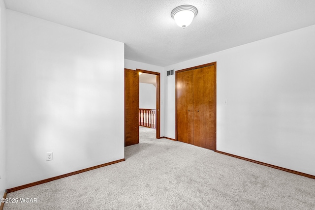 800 Heritage Dr, Lima, OH 45804 - empty room featuring carpet flooring and a textured ceiling