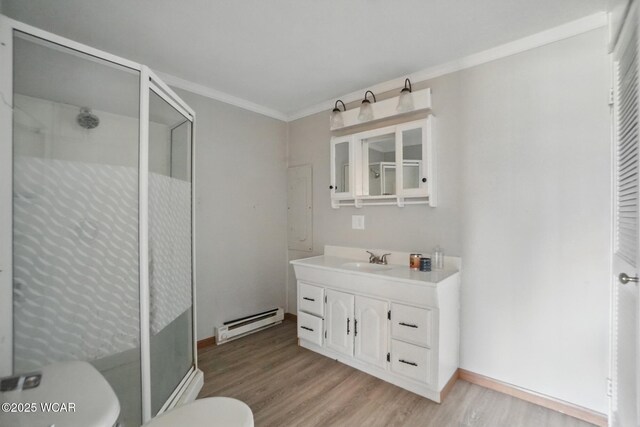 402 S Fifth St, Continental, OH 45831 - full bath featuring a baseboard heating unit, a shower stall, toilet, ornamental molding, and wood finished floors