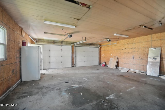 402 S Fifth St, Continental, OH 45831 - garage featuring a garage door opener and freestanding refrigerator
