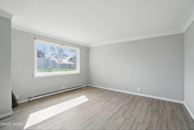 402 S Fifth St, Continental, OH 45831 - spare room with a baseboard heating unit, wood finished floors, and baseboards