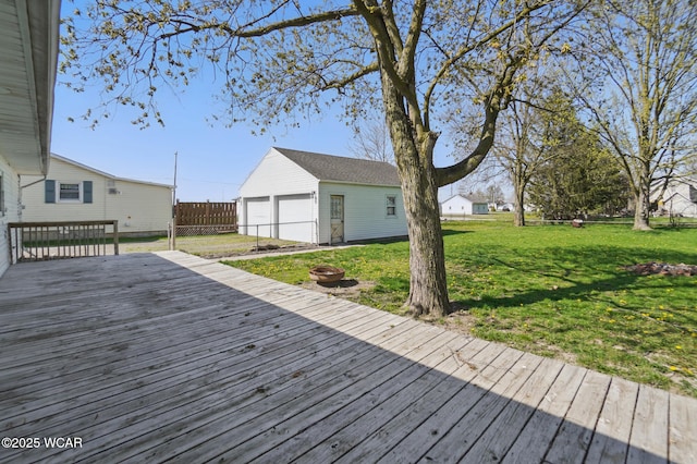 402 S Fifth St, Continental, OH 45831 - wooden terrace featuring fence, an outbuilding, an outdoor fire pit, a lawn, and a garage
