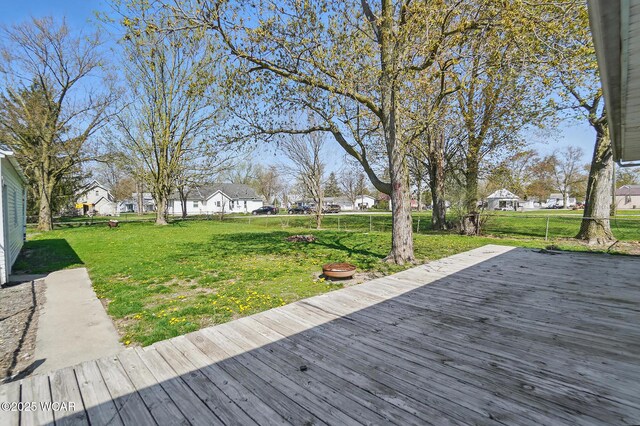402 S Fifth St, Continental, OH 45831 - wooden terrace featuring a fenced backyard, a residential view, and a lawn