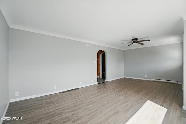 402 S Fifth St, Continental, OH 45831 - unfurnished room featuring arched walkways, a ceiling fan, baseboard heating, and wood finished floors
