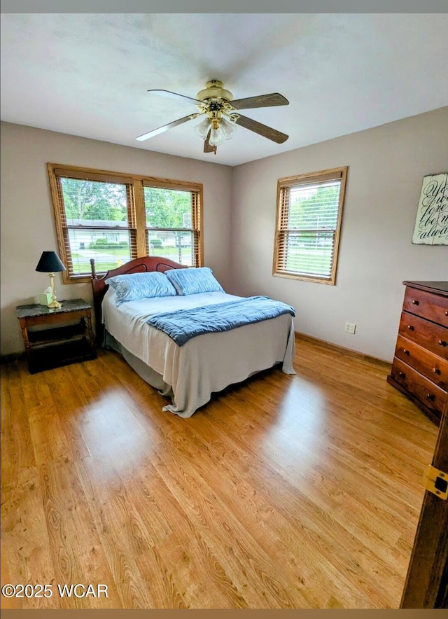 1756 Jo Jean Rd, Lima, OH 45806 - bedroom featuring multiple windows, light wood-type flooring, and a ceiling fan