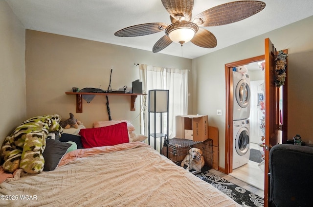 616 N Dix St, Paulding, OH 45879 - bedroom featuring stacked washer / dryer, ceiling fan, and wood finished floors
