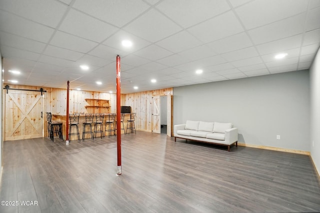 3467 Weldon Dr, Lima, OH 45806 - finished basement featuring baseboards, wood finished floors, a barn door, recessed lighting, and wood walls