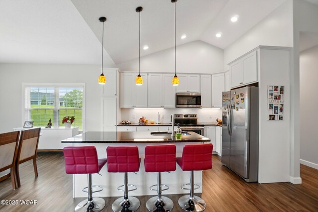 3467 Weldon Dr, Lima, OH 45806 - kitchen featuring stainless steel appliances, a sink, dark countertops, dark wood-style flooring, and tasteful backsplash