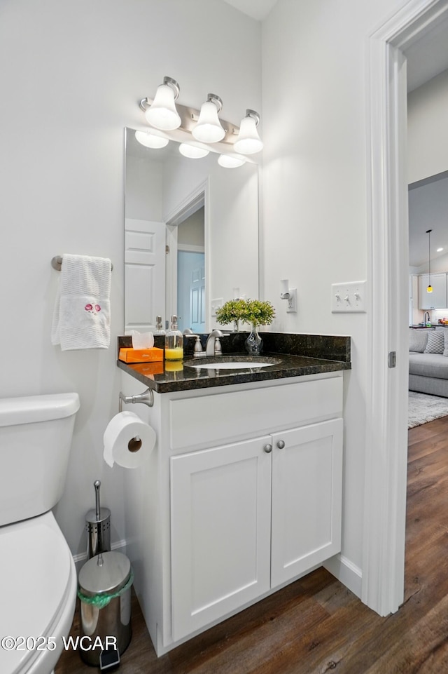 3467 Weldon Dr, Lima, OH 45806 - bathroom with toilet, vanity, wood finished floors, and baseboards
