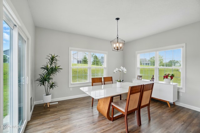 3467 Weldon Dr, Lima, OH 45806 - dining room featuring a chandelier, dark wood-style flooring, and baseboards