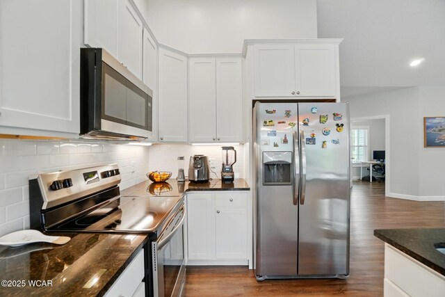 3467 Weldon Dr, Lima, OH 45806 - kitchen featuring appliances with stainless steel finishes, wood finished floors, backsplash, white cabinetry, and dark stone countertops