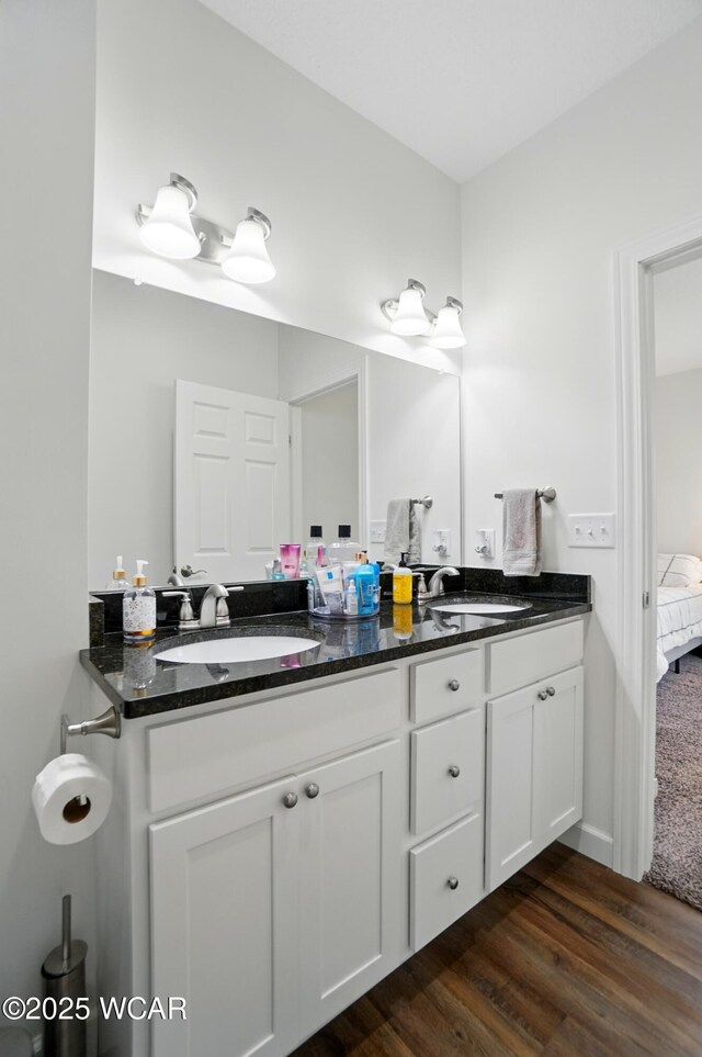 3467 Weldon Dr, Lima, OH 45806 - full bathroom with double vanity, wood finished floors, and ensuite bathroom