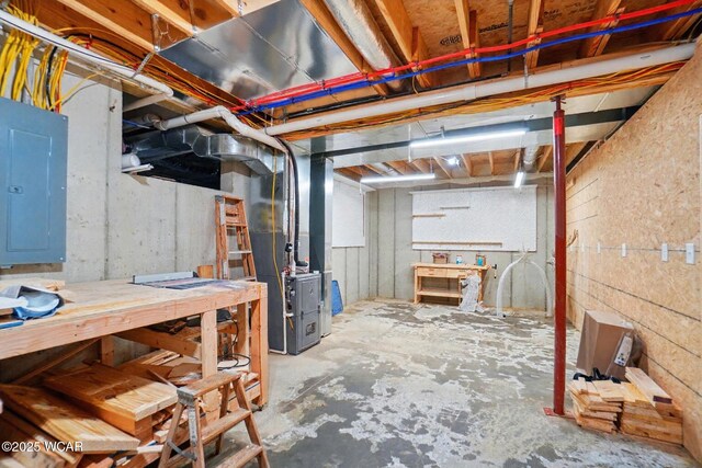 3467 Weldon Dr, Lima, OH 45806 - unfinished basement with electric panel, a workshop area, and heating unit
