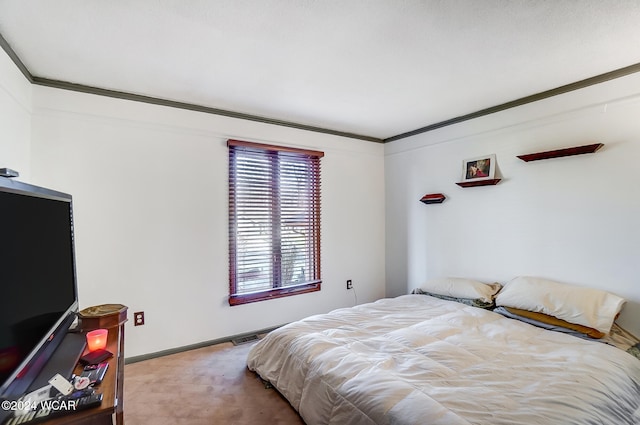 bedroom featuring baseboards, visible vents, and ornamental molding