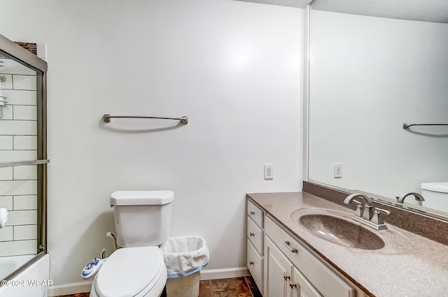 bathroom with baseboards, combined bath / shower with glass door, vanity, and toilet