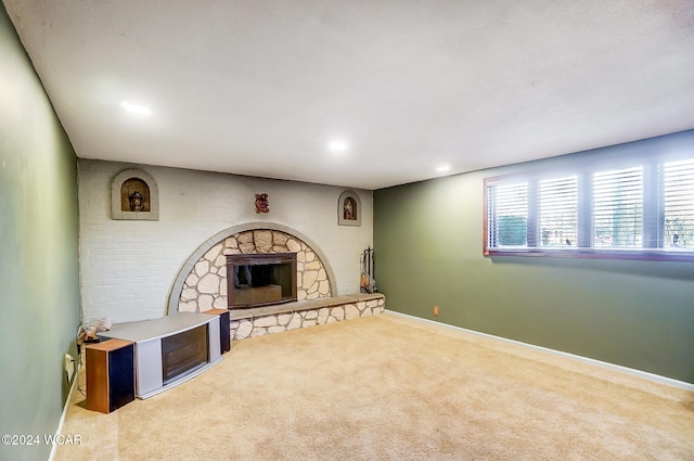 carpeted living area featuring recessed lighting, a fireplace, and baseboards