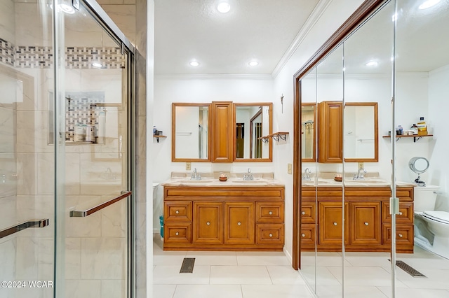 bathroom featuring a sink, toilet, and crown molding