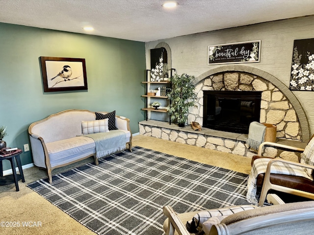 living area featuring a textured ceiling, carpet floors, a fireplace, and baseboards