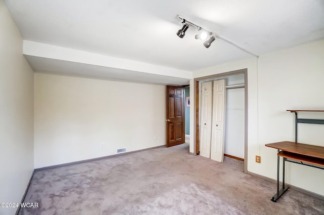 unfurnished bedroom with light carpet, visible vents, and baseboards