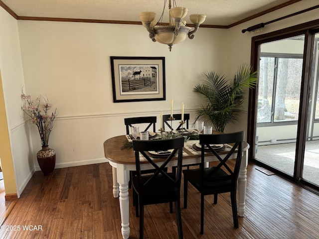 dining area featuring a textured ceiling, a chandelier, dark wood-type flooring, baseboards, and crown molding