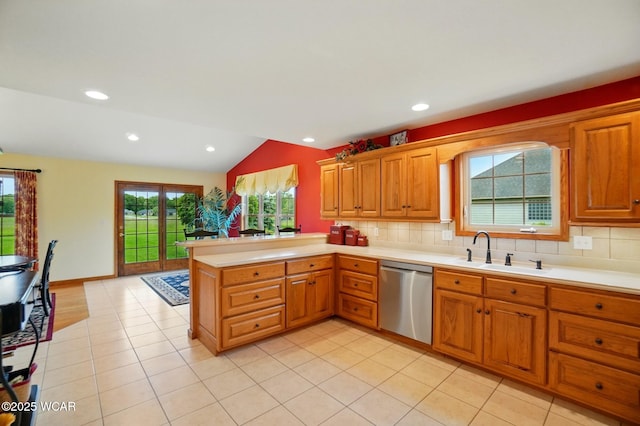 4042 Bur Oak Trl, Lima, OH 45807 - kitchen featuring stainless steel dishwasher, a sink, a peninsula, light countertops, and vaulted ceiling
