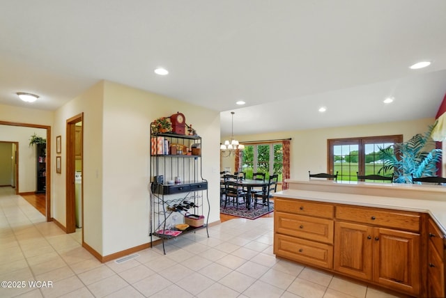 4042 Bur Oak Trl, Lima, OH 45807 - kitchen with a chandelier, light tile patterned flooring, light countertops, recessed lighting, and brown cabinets
