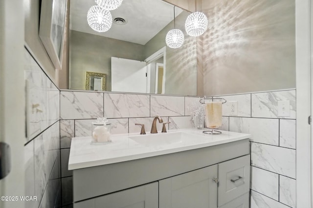 2101 Kimberly Dr, Lima, OH 45805 - bathroom featuring a chandelier, vanity, and tile walls