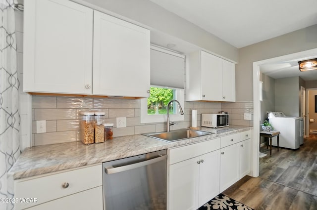 2101 Kimberly Dr, Lima, OH 45805 - kitchen featuring stainless steel dishwasher, white microwave, a sink, and white cabinetry