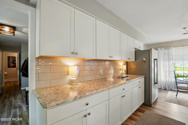 2101 Kimberly Dr, Lima, OH 45805 - kitchen with freestanding refrigerator, dark wood-style flooring, a baseboard radiator, and white cabinets