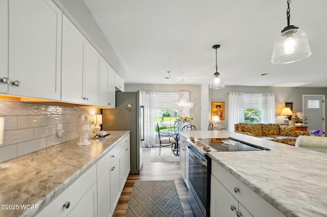 2101 Kimberly Dr, Lima, OH 45805 - kitchen with appliances with stainless steel finishes, white cabinets, dark wood-style floors, tasteful backsplash, and hanging light fixtures