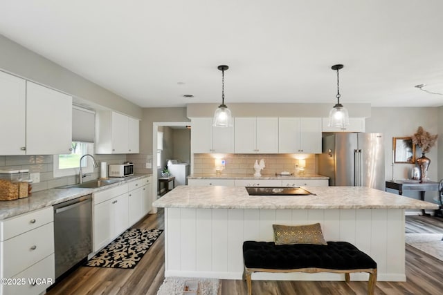 2101 Kimberly Dr, Lima, OH 45805 - kitchen featuring appliances with stainless steel finishes, a sink, dark wood-style floors, backsplash, and white cabinetry