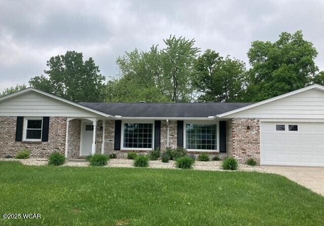 2101 Kimberly Dr, Lima, OH 45805 - ranch-style house with brick siding, a garage, a front lawn, and driveway