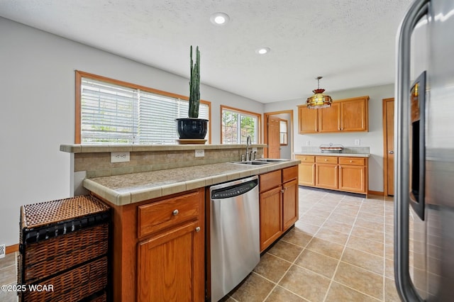 914 Howard St, Findlay, OH 45840 - kitchen featuring stainless steel dishwasher, refrigerator, a sink, light countertops, and light tile patterned floors