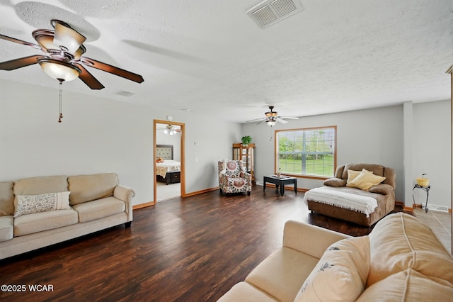 914 Howard St, Findlay, OH 45840 - living area featuring a ceiling fan, wood finished floors, baseboards, and a textured ceiling