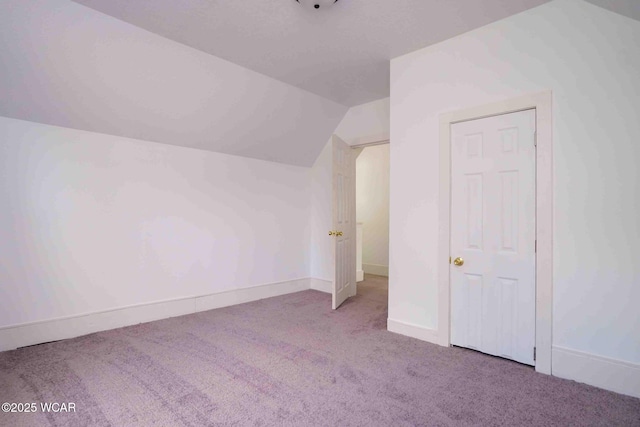 bonus room with vaulted ceiling, carpet flooring, and baseboards